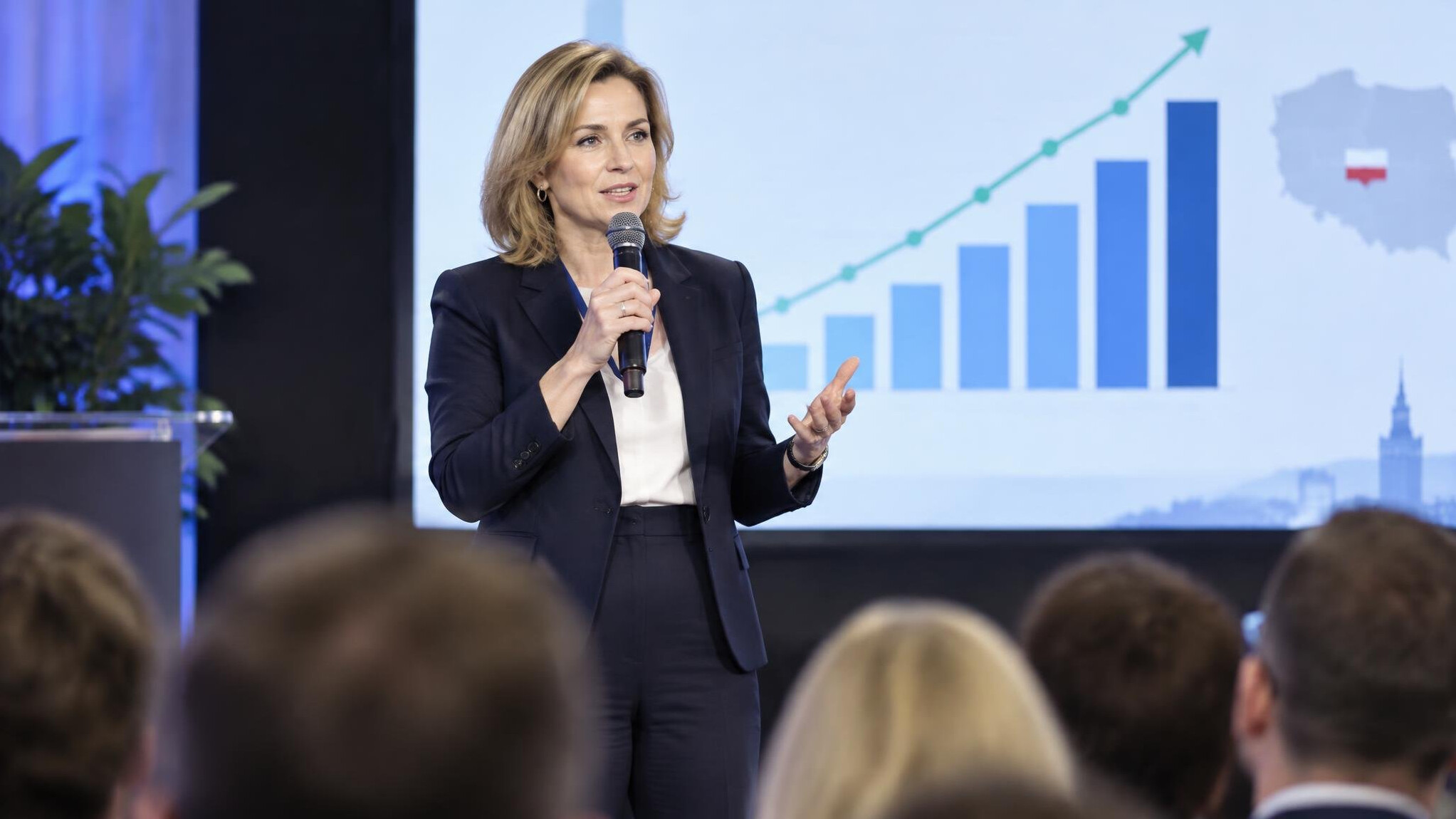 Speaker on conference stage with microphone